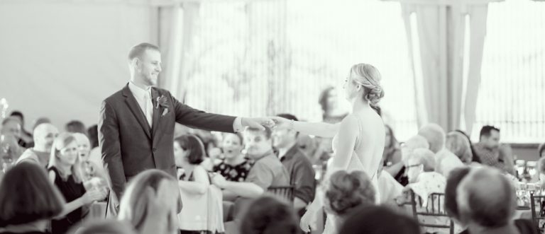 Wedding couple dancing their first dance in black and white.