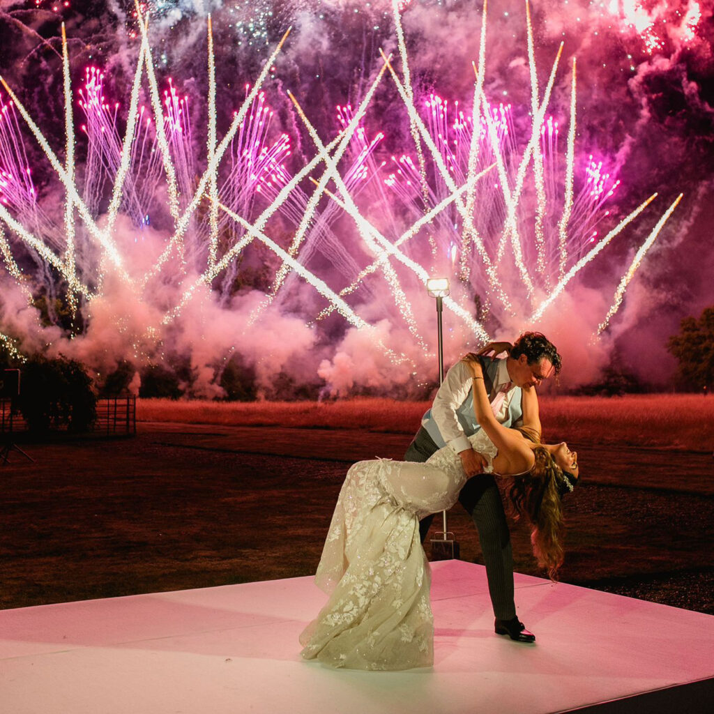 Bride and groom enjoying a relaxed first dance surrounded by guests