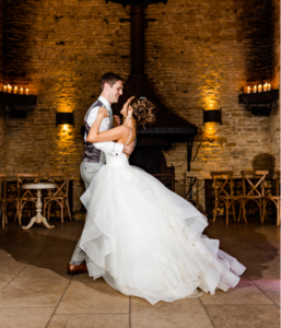 Groom leading bride during wedding dance choreography