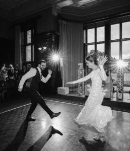 Couple enjoying their wedding first dance in front of guests