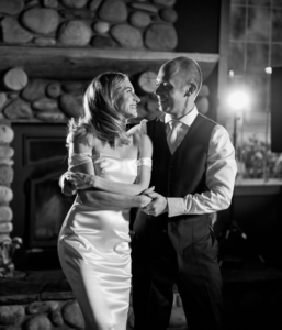 Bride and groom dancing their wedding first dance under soft lighting