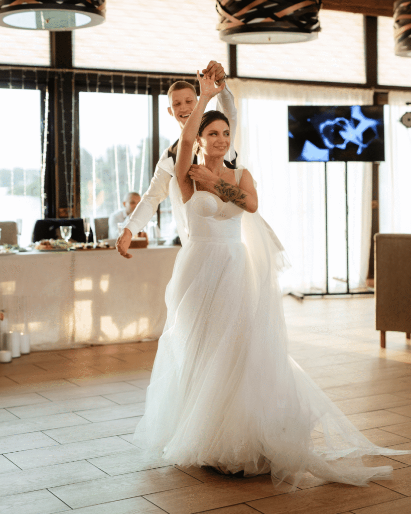 Bride and groom holding hands during their wedding first dance