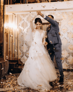 Newly married couple sharing a romantic first dance under warm lighting