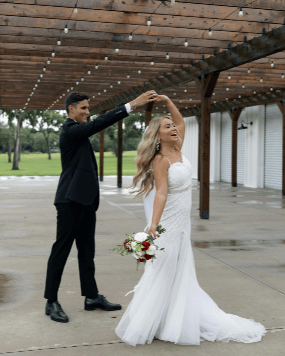 Happy newlyweds dancing their first dance together at their reception